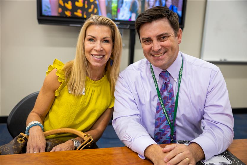 A PTO president wearing a yellow shirt and the Brentwood Middle principal
